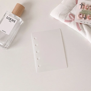 Macro detail of translucent frosted six-hole binder divider for nail art storage