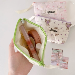 Quilted cotton makeup bag with floral and bear patterns featuring a zipper closure