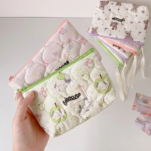 Close-up of cute quilted cartoon mini storage bags for lipsticks and earphones