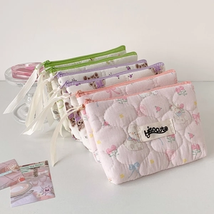 Stack of quilted cotton makeup bags with floral and bear patterns and ribbon zipper