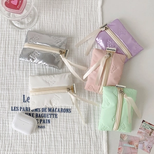 Puffy bow-knot coin purses in five colors with ribbon zippers and soft padding