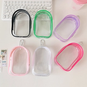 Detailed view of colorful transparent PVC mini doll bags with silver metal carabiners
