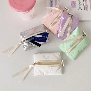 Close-up of quilted ribbon zip purses in five pastel colors showing bank card storage