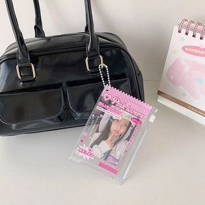 Y2K clear pink photocard holder keychain with zipper on a black handbag