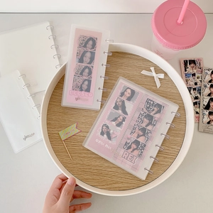 Macro detail of the transparent loose-leaf binder mechanism and photo storage pages
