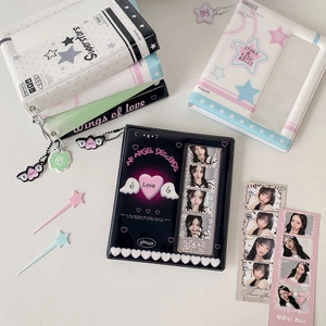 Detail view of colorful PVC photo albums with star designs and transparent card windows