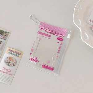 Detail view of a pink PVC card holder with a metal chain and sweet decorative patterns