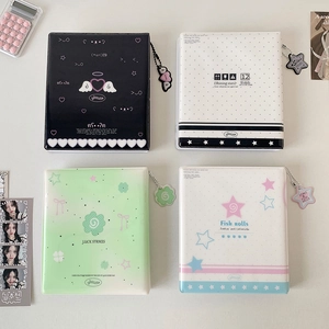 Top view of four assorted minimalist photo albums with matching charms and stickers