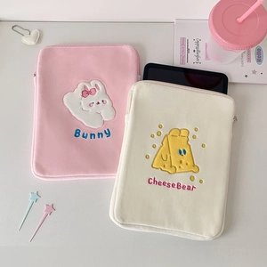 Close-up of plush rabbit and bear embroidery on pink and white 11-inch iPad sleeves