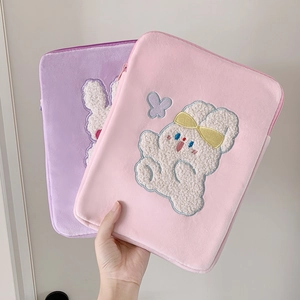 Close-up of plush tablet sleeve featuring cute rabbit embroidery and soft fuzzy texture