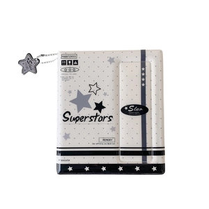 Star-patterned photo album featuring 'Superstars' text and a decorative star charm