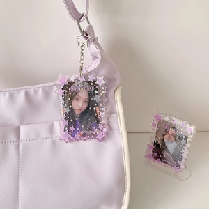 Purple acrylic star keychain and stand set shown attached to a canvas bag with metal clasp