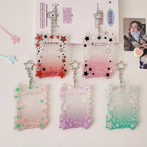 Five assorted star-themed acrylic photo card holders with vibrant wave edges and keychains