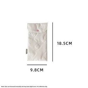 Detailed view of quilted white stationery bag with pink heart snap and Hisocute tag
