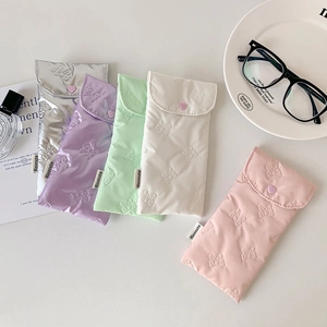 Pastel quilted bow pattern glass case collection with heart snaps on white desk