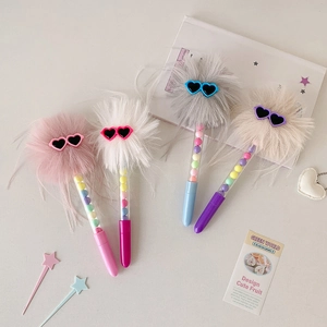 Close-up of cute plush pens with fluffy balls, heart sunglasses, and beaded transparent tubes