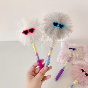 Detail of creative plush ball pen with heart sunglasses and colorful beads in the barrel