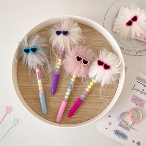Detailed view of four colorful plush pens with heart-shaped sunglasses and pastel beads