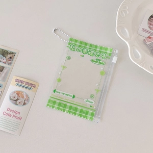 Macro shot of green checkered PVC card holder with bead chain and luck text detail