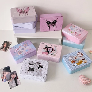 Detail of colorful printed tin storage boxes with butterfly and retro car designs