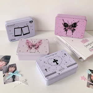 Macro shot of rectangular tin boxes with vintage butterfly and heart prints for desk storage