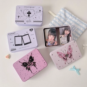 Detail of vintage tin storage box showing photo card organizer and butterfly print