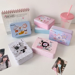 Minimalist aesthetic tin storage box with diverse cute prints on a clean desktop