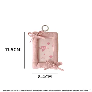 Detailed view of pink fabric card holder with bow accents and clear display window
