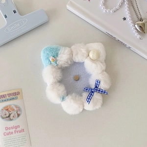 Close-up of plush blue rosette badge holder with a plaid bow and white rabbit charm