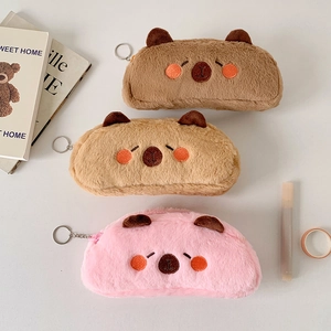 Detailed close-up of plush animal pencil cases in brown and pink with embroidery
