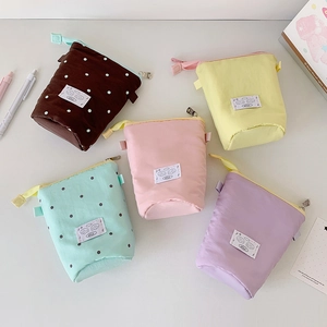 Detailed view of pastel macaron canvas pencil cases in five colors with cute cartoon patches