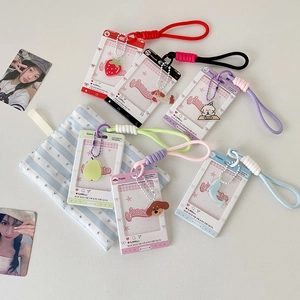 Detailed view of colorful acrylic idol photo holders with themed charms and hand straps
