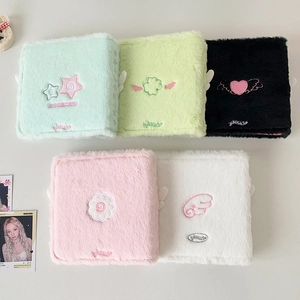Detail of plush binder covers with delicate angel wing and star embroidery