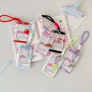 Detail of colorful sliding card holders with braided lanyards and acrylic charms