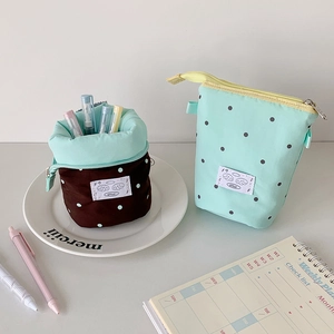 Telescopic canvas pencil case in polka dot design that transforms into a desktop pen holder