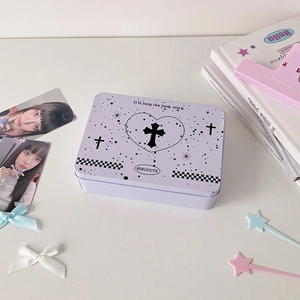 Detail of lavender tin storage box with gothic cross design and checkered patterns