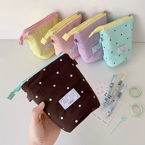 Close-up of minimalist canvas pencil cases with contrasting zippers and fabric pull tabs
