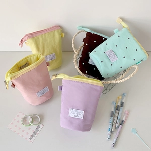 Vertical minimalist canvas stationery pouches in various colors with cute cartoon labels