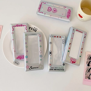 Detail of silver laser photocard holders with holographic heart and star patterns