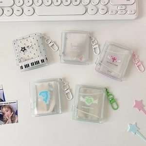 Flat lay of mini glitter PVC photo albums with sweet heart designs and plastic hooks