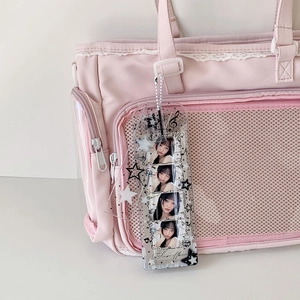 Detail of transparent glitter PVC photocard holder with four-frame vertical photo display
