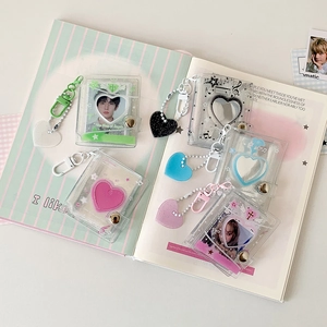 Close-up of glittery heart-shaped PVC mini photo albums in assorted pastel colors