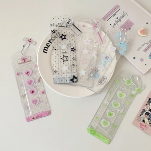 Detailed view of clear glitter PVC card holders with heart patterns and beaded chains