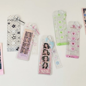 Detail of glitter PVC photo holders with music motifs and heart charms for idol cards