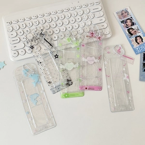 Detailed view of transparent glitter PVC card holders with cute musical and dolphin motifs