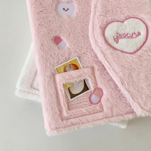 Close-up of pink plush A5 binder cover with heart embroidery and clear card slot