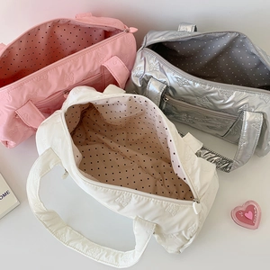 Detail showing the ribbon quilted texture, polka dot lining, and 3 colors of crossbody bags