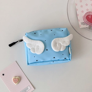 Macro detail of a light blue mini pouch with plush white wings and star patterns