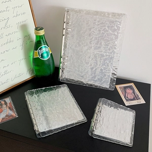 Detail of transparent water ripple texture PVC binder with metallic rings and inserts