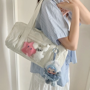 Quilted white shoulder bag with clear front pocket and cute plush toy decorations